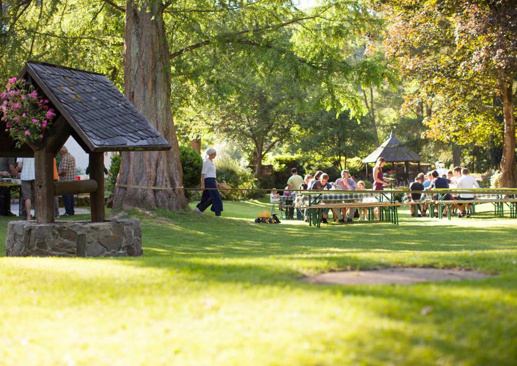 Eine Freizeitgruppe sitzt im Garten der Klostermühle
