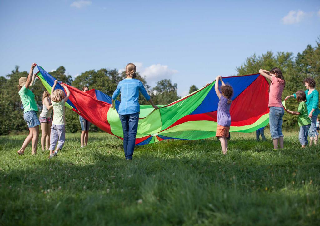 Eine Gruppe Kinder spielt mit einem bunten Tuch